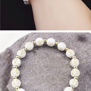 count of four Gold and White Beaded Bracelet